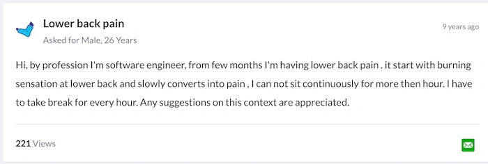 A software developer experiencing back pain at their desk